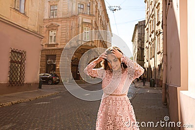 Lovely tanned model posing in fashionable apparel at the street Stock Photo