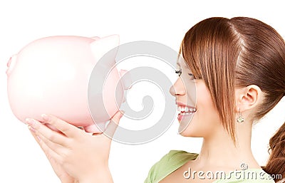 Lovely teenage girl with piggy bank Stock Photo