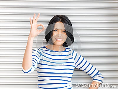 Lovely teenage girl showing ok sign Stock Photo