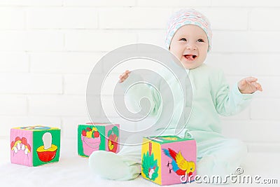 Little girl playing with colorful cubes Stock Photo