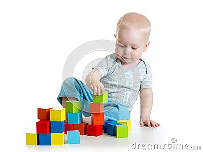 Lovely toddler baby playing with building cubes. Isolated on white. Stock Photo