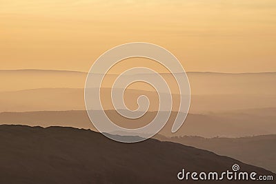 Lovely Winter landscape view from Red Screes across misty layers of mountains towards the East Stock Photo