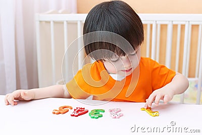 Lovely 2 years child learns to count. Educational game Stock Photo