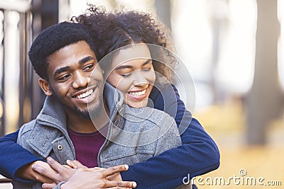 Lovely black couple cuddling while date in autumn park Stock Photo