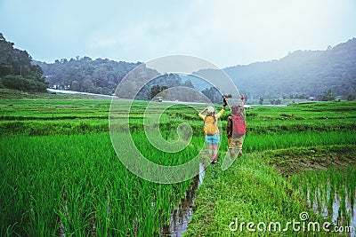 Lover asian men asian women travel nature Travel relax Walking a photo on the rice field in rainy season in Chiang Mai, Thailand Stock Photo