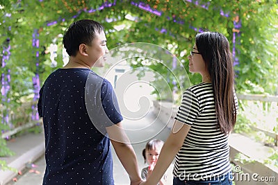 Happy family spouse husband or wife lover sweet beautiful parent and child relationship hand in hand enjoy free time summer park Stock Photo