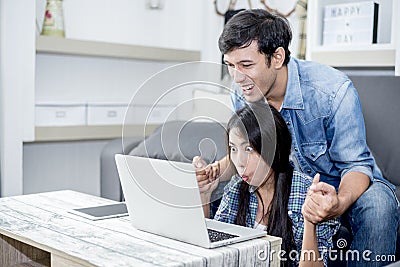 Lover are surprising when using the laptop. Family concept, Lovers concept, Technology concept Stock Photo