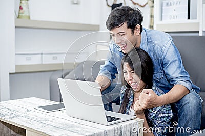 Lover are surprising when using the laptop. Family concept, Lovers concept, Technology concept Stock Photo