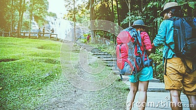 Lover women and men Asian travel nature. Travel relax. Natural Touch countryside. On the Moutain. At Waterfall Use summer. Stock Photo