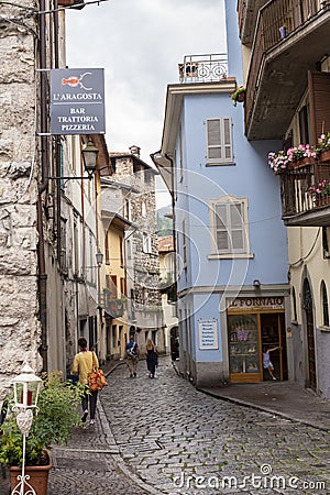 Lovere, Italy - June 28, 2017: Narrow street with houses with tiled roofs in an Italian town Editorial Stock Photo