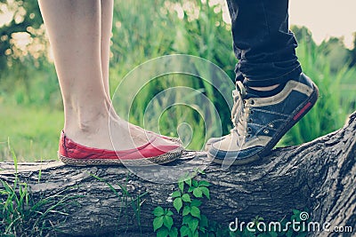 Lovers` feet on a tree branch Stock Photo