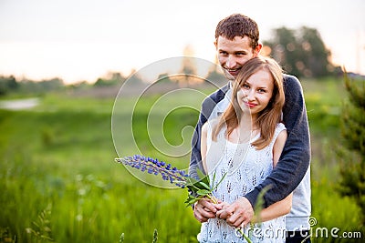 Lovers hugging in the lupins Stock Photo