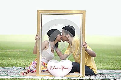 Lovers kissing in the park Stock Photo