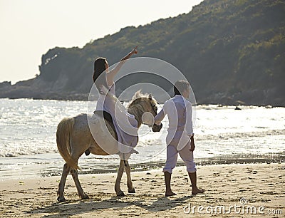 Lovers walking on beach Stock Photo