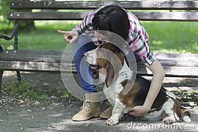 She loves dogs. Woman sits on a bench in the park with his beaut Stock Photo