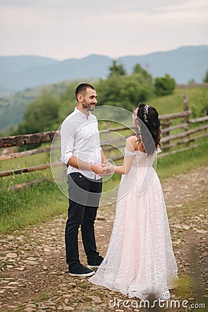 Lovestory of beautiful couple in the mountains, Handsome bearded man with beautiful and charming woman Stock Photo