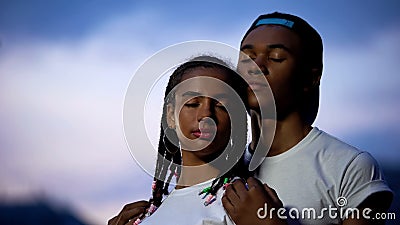 Loving african couple hugging, closing eyes to dream about happy future together Stock Photo