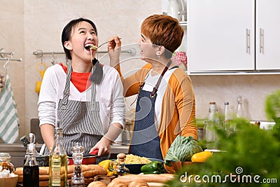 Loving Asian family of mother and daughter cooking in kitchen Stock Photo