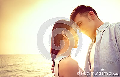 Loving asian young couple kissing at sunset. Valentine`s day Stock Photo
