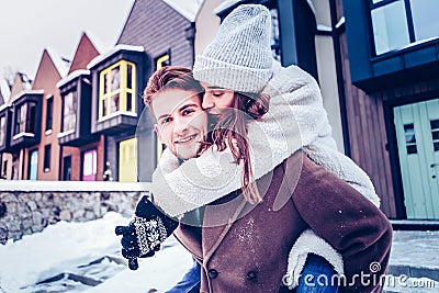 Loving beautiful girlfriend kissing her handsome blue-eyed man Stock Photo