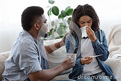 Loving Black Man Caring About His Ill Spouse At Home Stock Photo