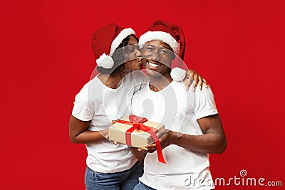 Loving black woman giving her husband New Year gift Stock Photo