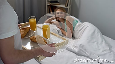 Loving boyfriend holding tray with breakfast for his beloved, Valentines day Stock Photo