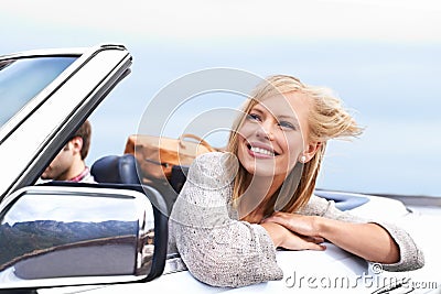 Loving the breeze in her face. a young couple enjoying a drive in a convertible. Stock Photo