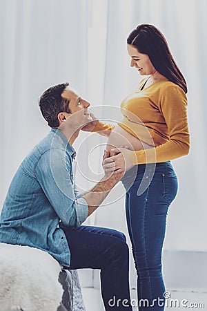 Handsome man raising head while looking at his wife Stock Photo