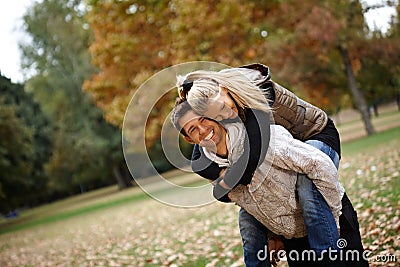 Loving couple in autumn park laughing Stock Photo