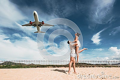 Loving couple on the beach near the airport Stock Photo