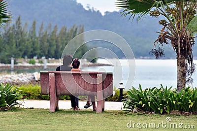Loving couple on a bench Editorial Stock Photo