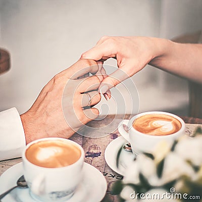 Loving couple drink coffee after the wedding. Hands newlyweds Stock Photo