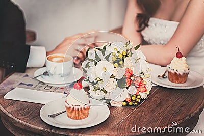 Loving couple drink coffee after the wedding. Hands newlyweds Stock Photo