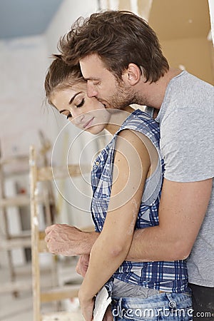 Loving couple embracing at home renovation Stock Photo