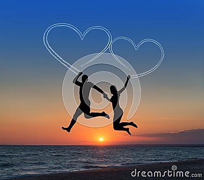 Loving couple flying it sky against sea beachand heart-shaped Stock Photo