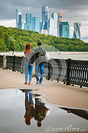 A loving couple going along the embankment of the Moscow river Editorial Stock Photo