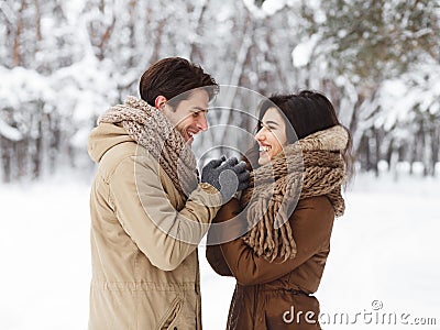 Loving Couple Holding Hands Standing Having Romantic Winter Date Outside Stock Photo