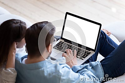 Loving couple looking at laptop screen blank white mockup Stock Photo