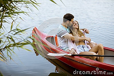 Loving couple rowing on the lake Stock Photo