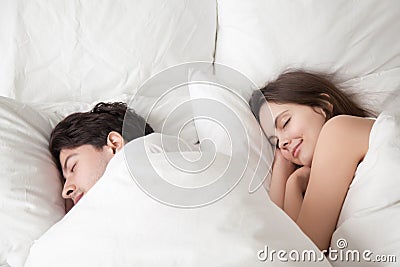 Loving couple sleeping peacefully in comfortable bed, falling as Stock Photo