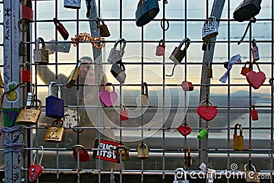 Loving Couple Taking Selfie Behind Wall of Love Lock Editorial Stock Photo