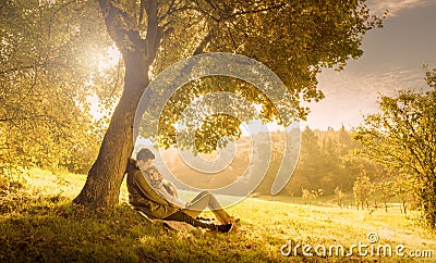 Loving couple under a big tree Stock Photo