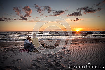 Loving couple watching sunset Stock Photo