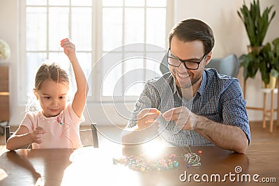 Loving dad and small daughter engaged in creative activity Stock Photo