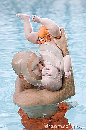 Loving father and baby having fun in swimming pool Stock Photo