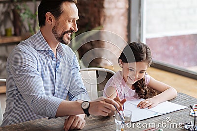 Loving father and his little girl painting a picture Stock Photo