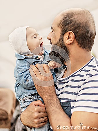 A loving father holds a child in his arms. Emotional photo. Stock Photo