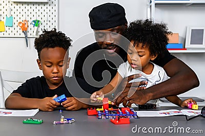 Loving Father Teaches and Plays with Son at Home for Learning and Education on Electric Circuit and Skill Development. Father Stock Photo