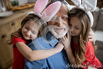 Loving girls hugging their grandpa stock photo Stock Photo